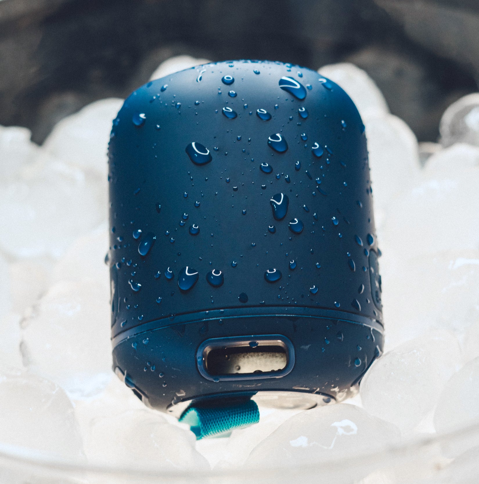 A blue wireless speaker in an ice bucket