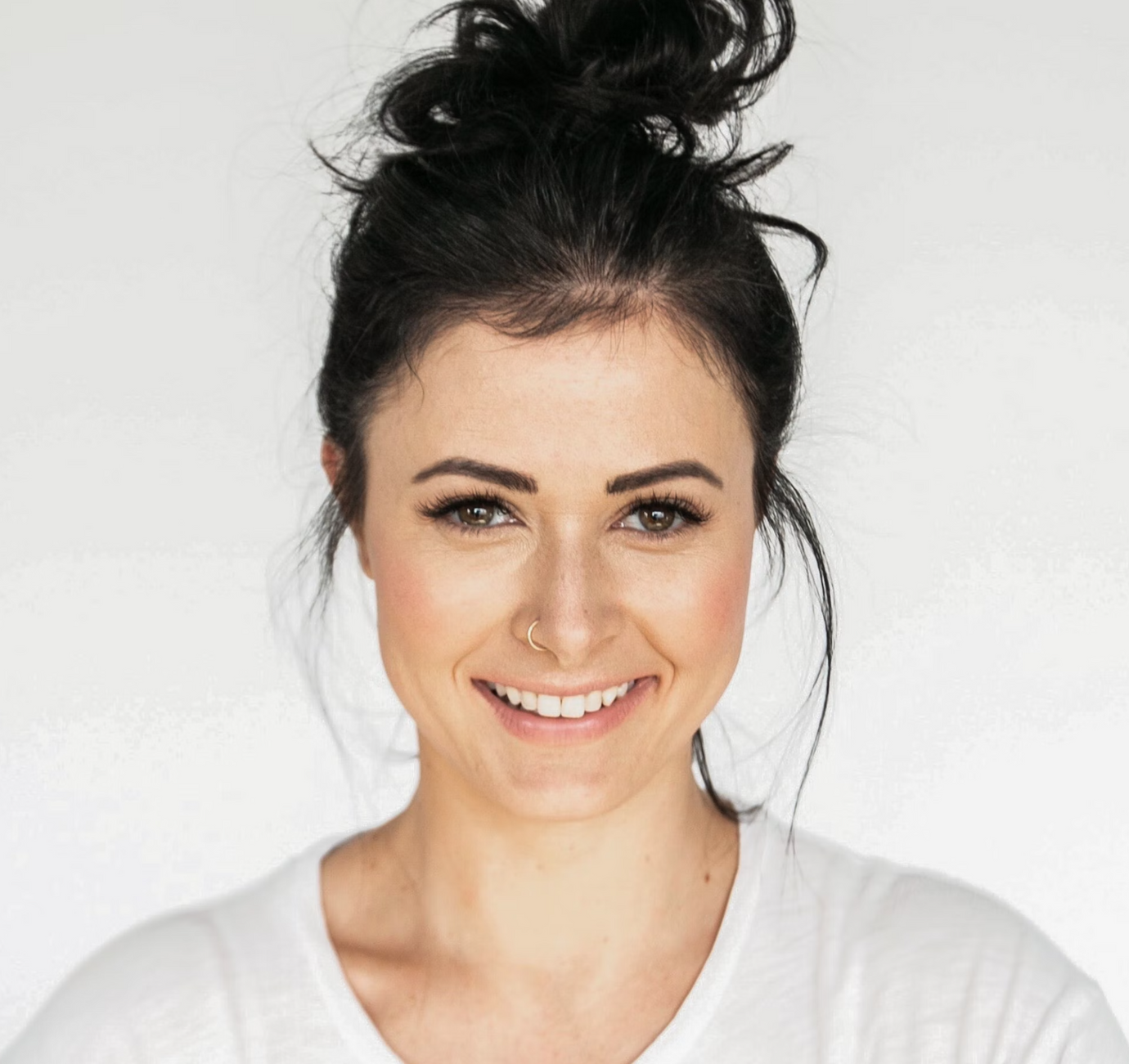 Portrait of a smiling woman wearing a white shirt