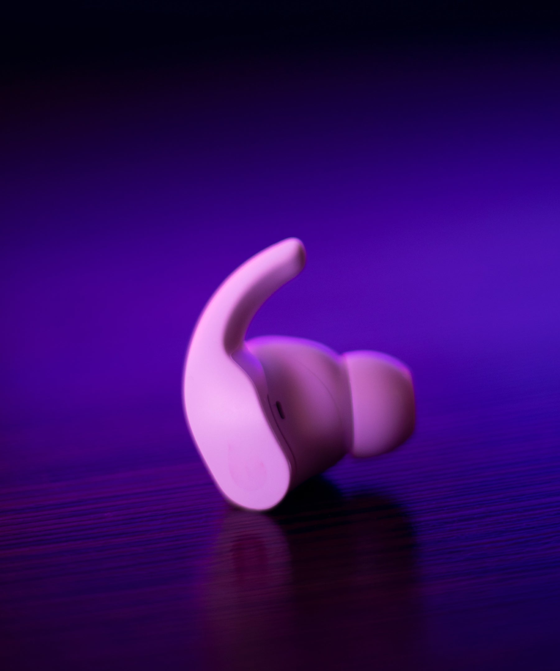 A white earbud on a table top