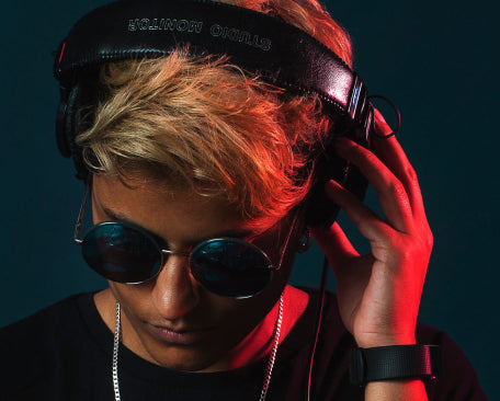 A blond man wearing sunglasses and headphones